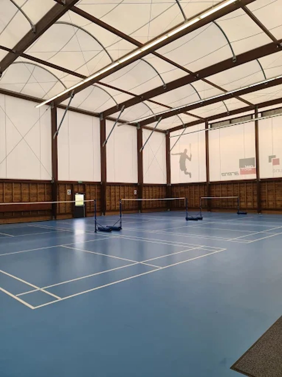Two badminton players high-fiving